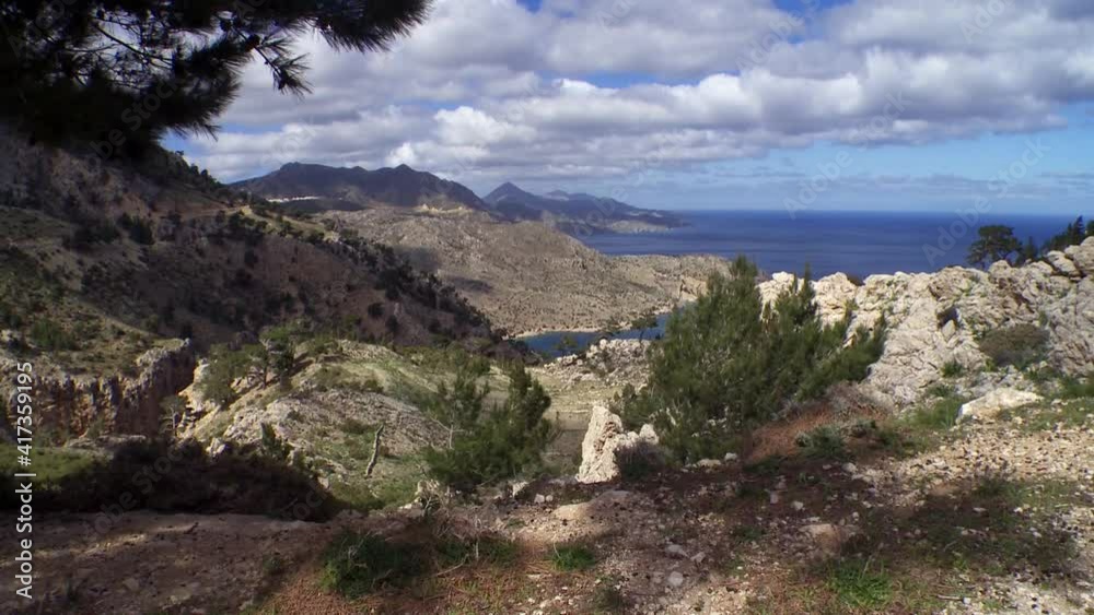 Karpathos Greece a classic landscape of the island sea mountains islands and clouds Pine trees Karpathos Greece a classic landscape of the island sea mountains islands and clouds Pine trees