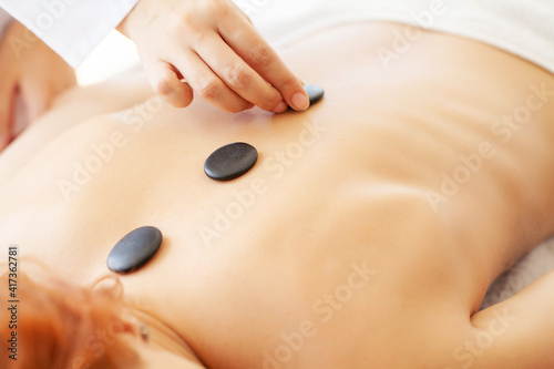 Beautiful woman spa hot stone massage beauty Treatments