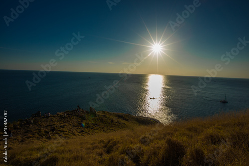 The natural background of the morning light rising in the middle of the sea and surrounded by mountains  cool breezes  the beauty of the ecology of the tourist attractions.