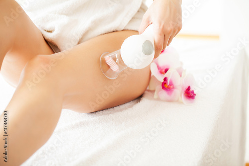 Woman getting LPG massage for skin care in beauty studio