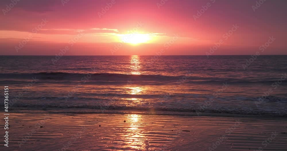 Red sunsets sky over beach sea. The sun touches horizon. Rose gold sky, Fantastic natural twilight sky. Red sunsets sky over beach sea. The sun touches horizon. Rose gold sky, Fantastic natural twilight sky.