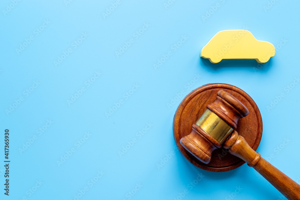 Car shape with judge gavel. Driving and insurance law concept Car shape with judge gavel. Driving and insurance law concept