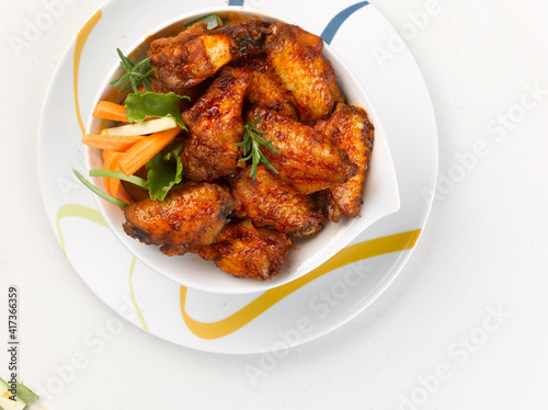 plate of marinated chicken wings, on white background