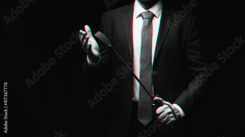 male dominant holds a leather whip Flogger for hard BDSM sex
