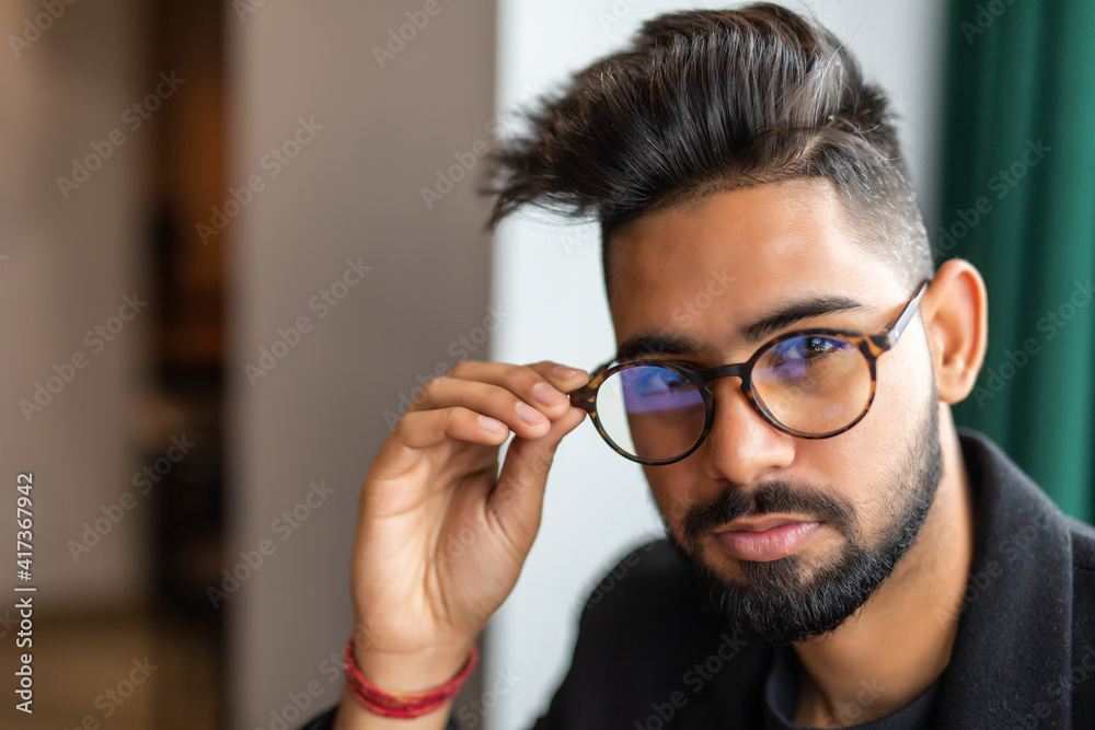 Indian business man in glasses in cafe Indian business man in glasses in cafe