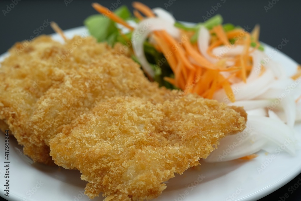 Breaded Fried Fish steak on white plate Breaded Fried Fish steak on white plate