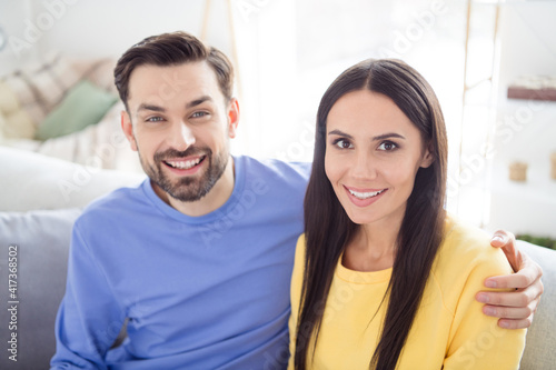 Photo of young cheerful couple happy positive smile hug cuddle husband wife together relationship indoors