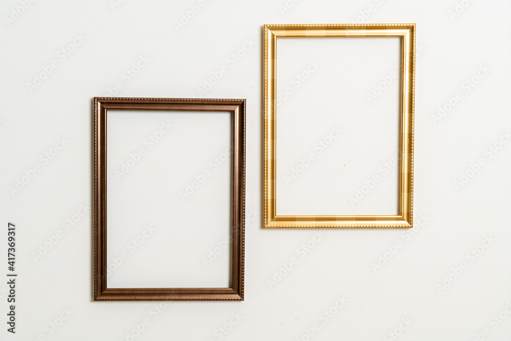 empty picture frame on white wall background empty picture frame on white wall background