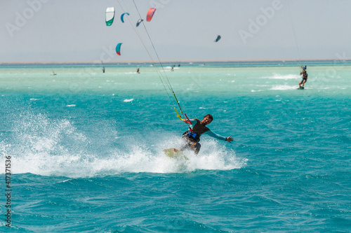 Kitesurfing on the waves of the Red sea, Egipt. Kitesurfing, Kiteboarding action photos Kitesurfer In action © Oleg