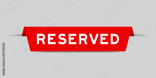 Red color inserted label with word reserved on gray background