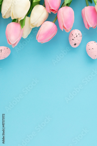 Easter invitation with tulips on a blue background with copyspace