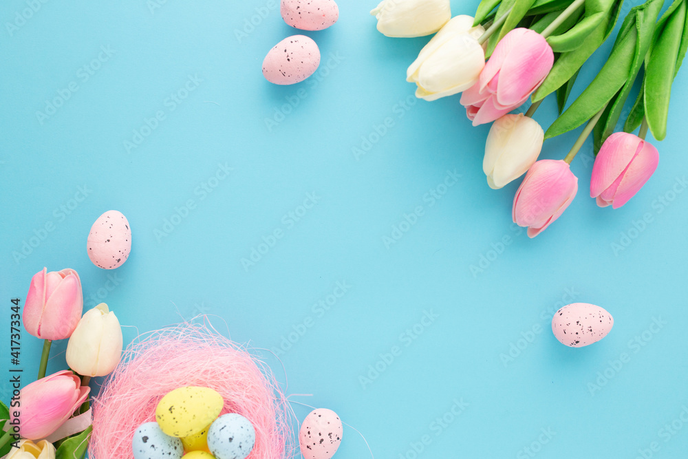 Easter invitation with tulips on a blue background with copyspace