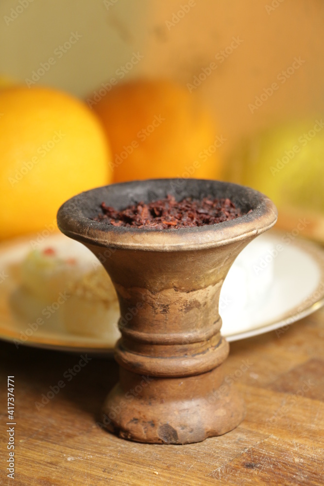 bowl with hookah tobacco. shisha with fruits on black background. bowl with hookah tobacco. shisha with fruits on black background.