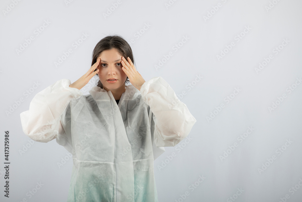 Portrait of young female doctor scientist in defensive lab coat posing Portrait of young female doctor scientist in defensive lab coat posing