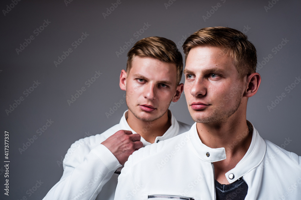 twins brother in white. male beauty and fashion. similar appearance. family relations and friendship twins brother in white. male beauty and fashion. similar appearance. family relations and friendship