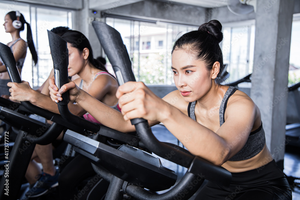 Fototapeta premium People working out at spinning class in the gym.