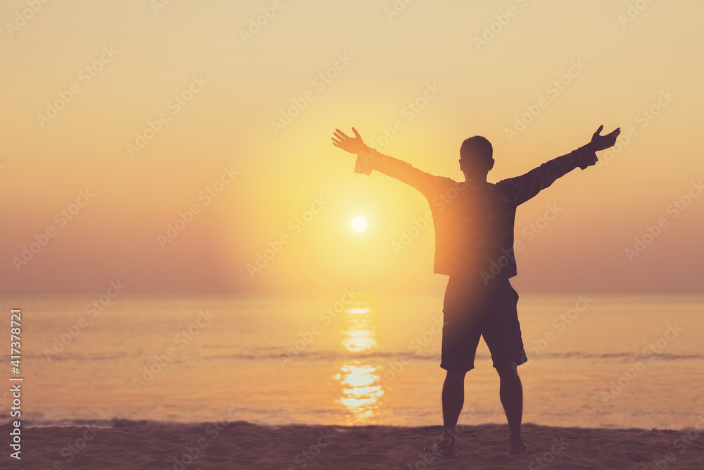 Copy space of man rise hand up on sunset sky at beach and island background.