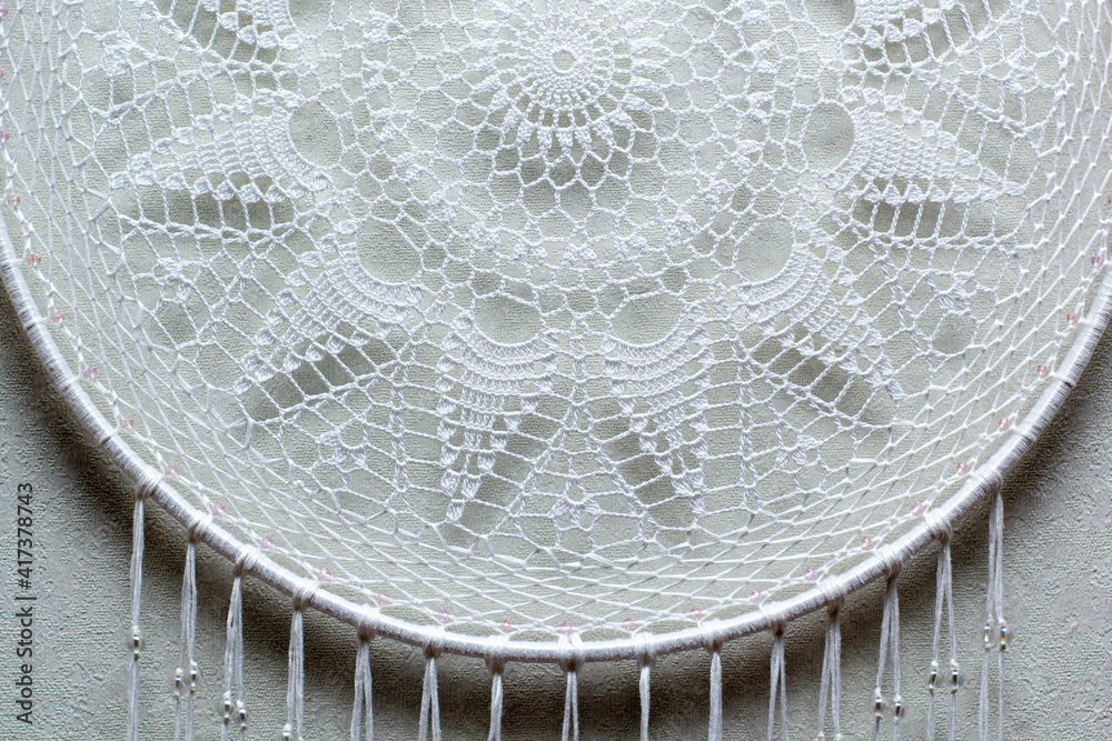 Handmade dream catcher with feathers threads and beads rope hanging on white background Handmade dream catcher with feathers threads and beads rope hanging on white background