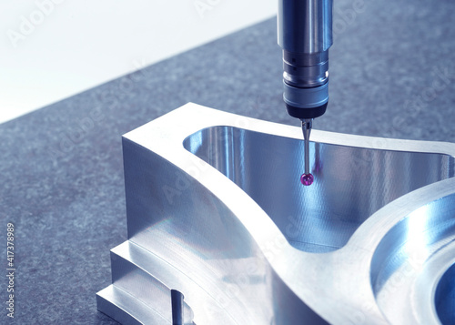 Engineering Metrology, A probe from a coordinate measurement machine taking measurements from a engineering part as part of its quality control process in manufacturing