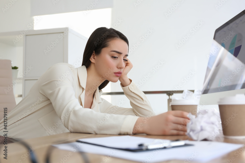 Businesswoman stressing out at workplace in office Businesswoman stressing out at workplace in office