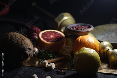bowl with tobacco for hookah on a dark background. berries on a black table. shisha smoking