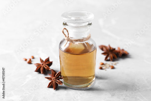 Fototapeta Naklejka Na Ścianę i Meble -  Anise essential oil and spice on light table