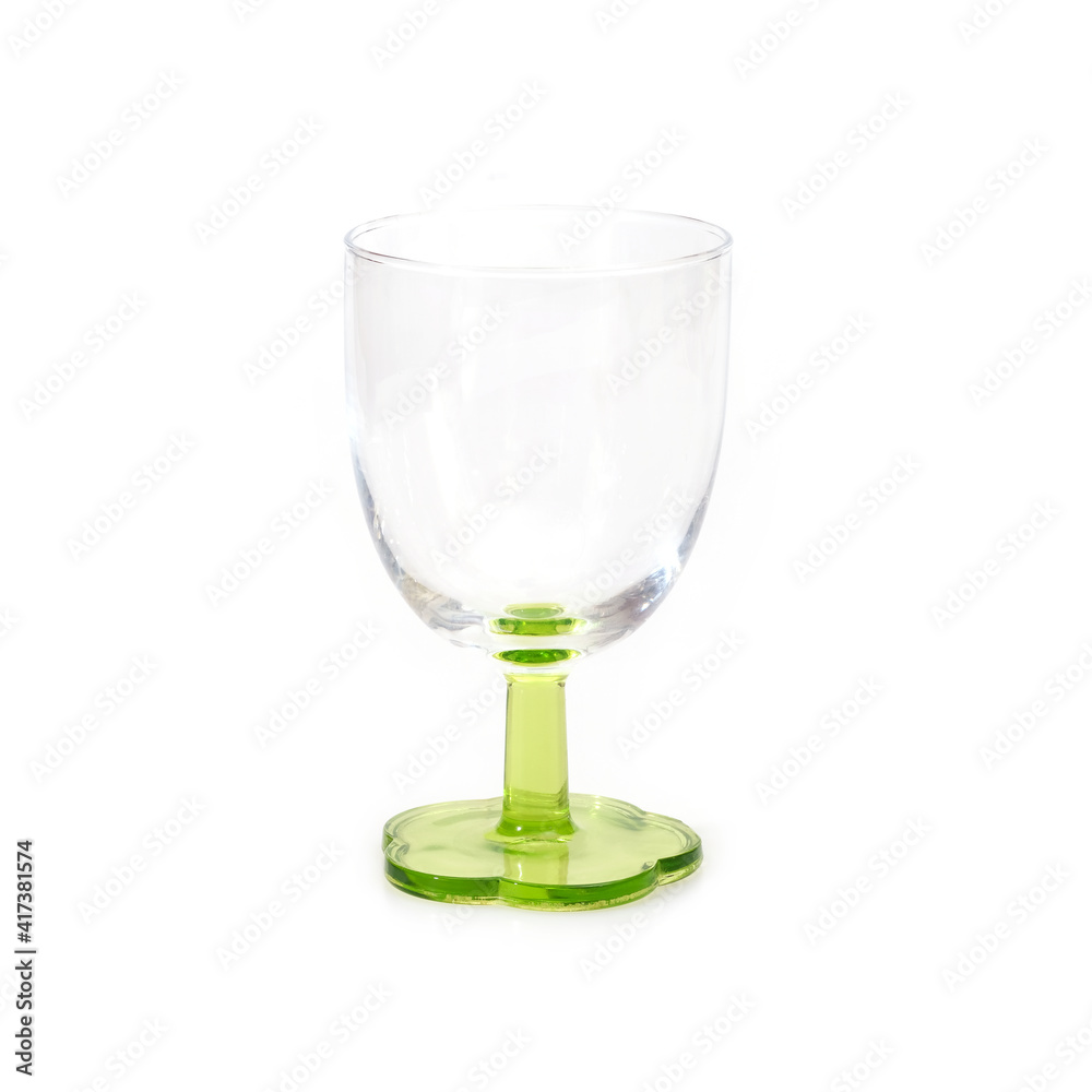 Empty glass goblet on green stem isolated on white background Empty glass goblet on green stem isolated on white background