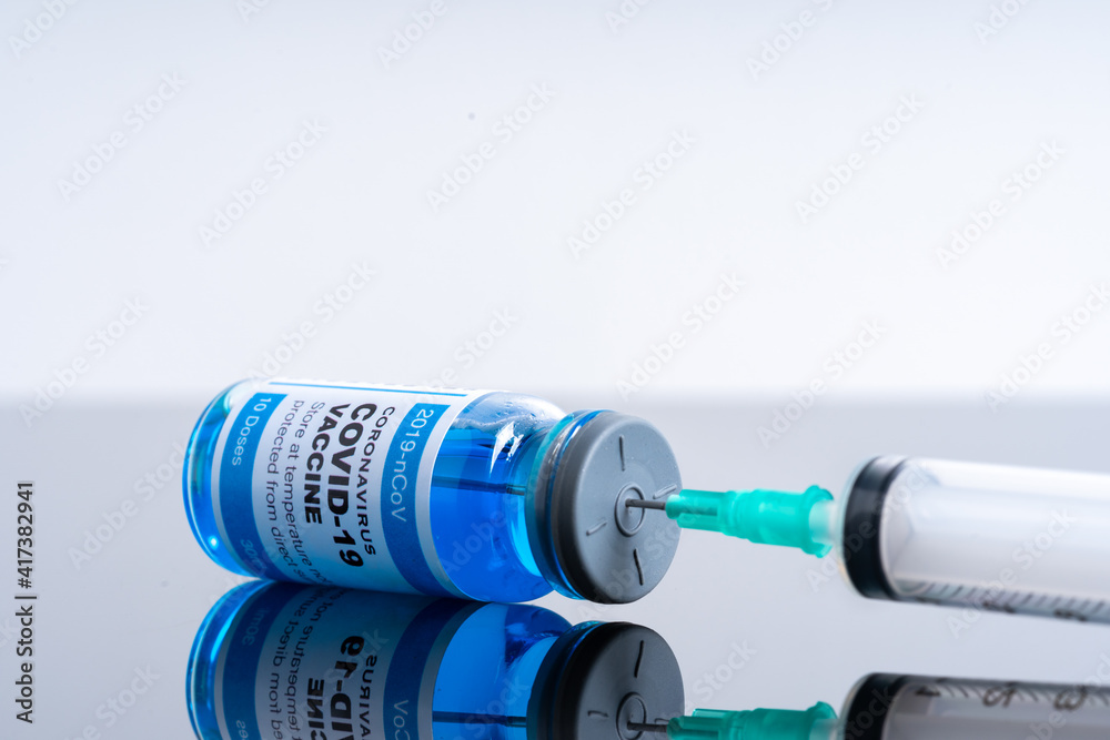 Medical concept ampoules or vials with Covid-19 vaccine on a laboratory bench Medical concept ampoules or vials with Covid-19 vaccine on a laboratory bench