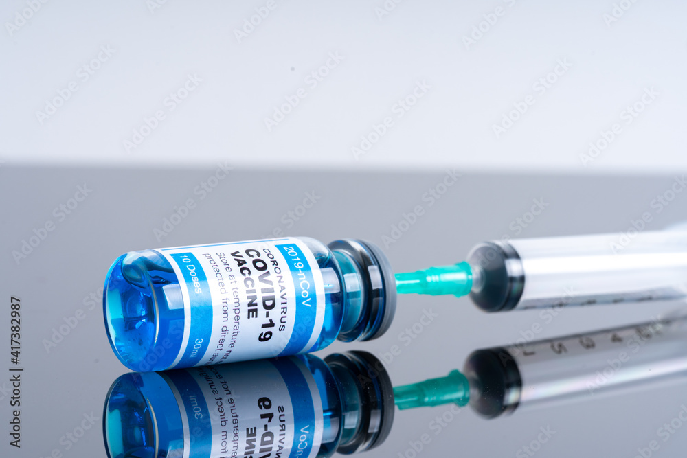 Medical concept ampoules or vials with Covid-19 vaccine on a laboratory bench Medical concept ampoules or vials with Covid-19 vaccine on a laboratory bench