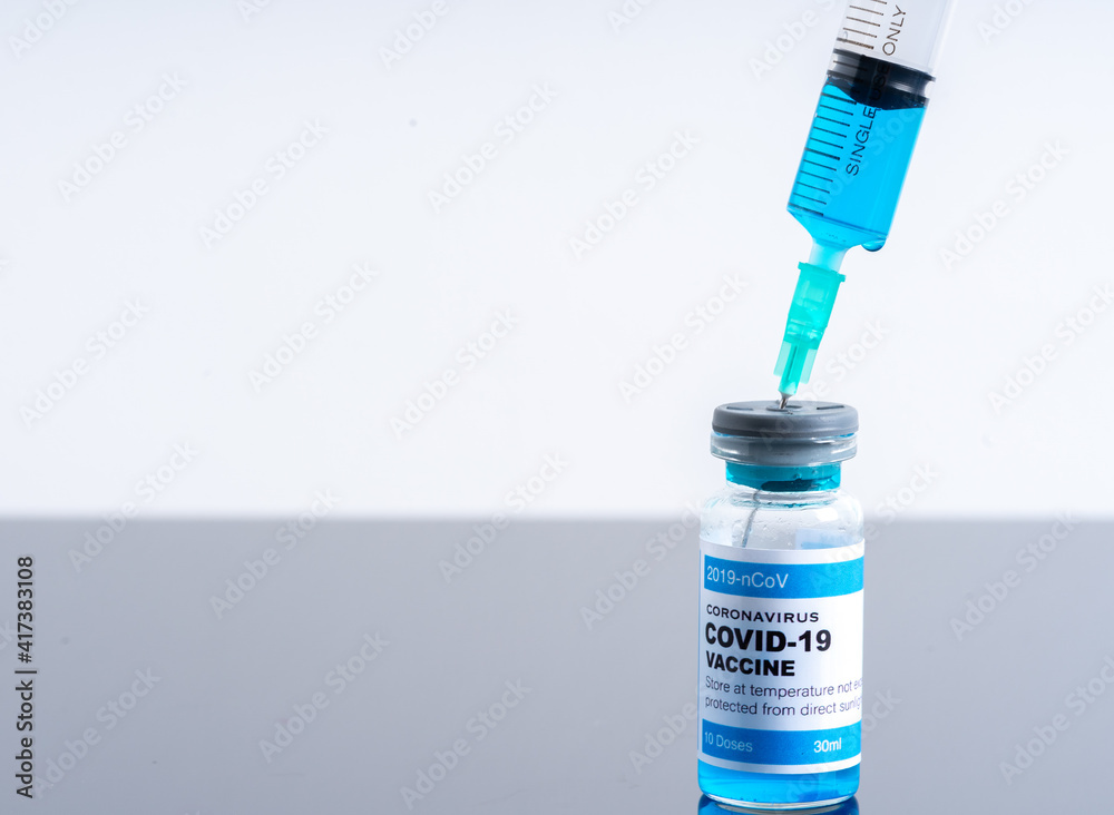 Medical concept ampoules or vials with Covid-19 vaccine on a laboratory bench Medical concept ampoules or vials with Covid-19 vaccine on a laboratory bench
