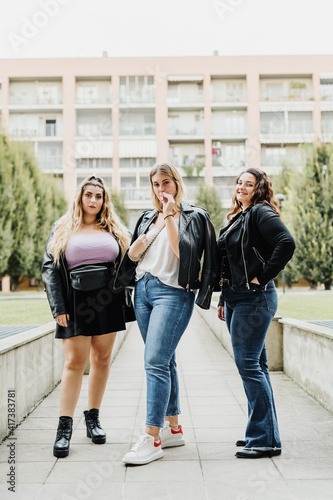 Three young women outside their apartment block
