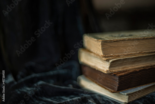 endpaper of vintage books, collection of old antique ancient books on black background, vintage books on black velvet fabric as background, velvet background, copy space