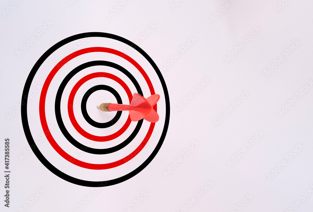 Red dart arrow hit on target board and white background, Business Achievement objective target concept. Red dart arrow hit on target board and white background, Business Achievement objective target concept.