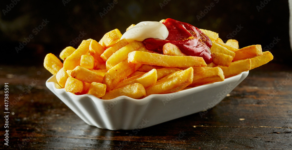 Delicious French fries with sauces in porcelain bowl StockFoto Adobe