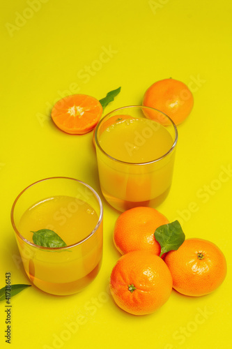Sweet fruit jelly from fresh oranges and tangerines on summer yellow background