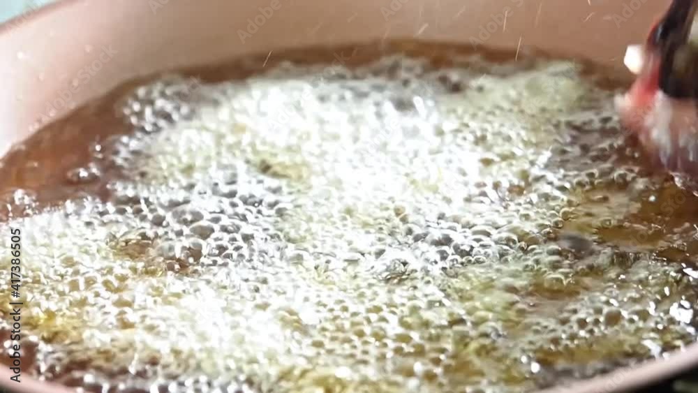 Fried meat in boiling oil close up Fried meat in boiling oil close up