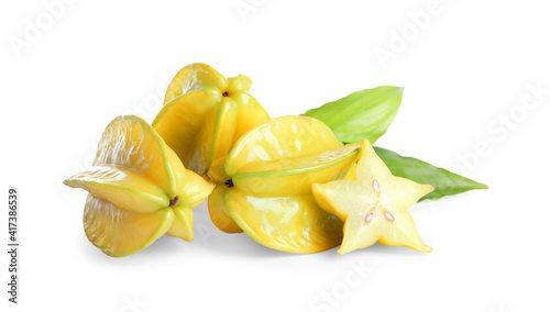 Cut and whole carambolas with green leaf on white background