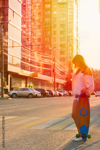 Young woman in tank top and shorts on the street