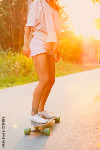 Young woman riding a skateboard in the city