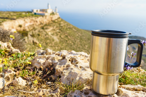 Thermal mug, thermos on nature. Travel outdoor picnic.