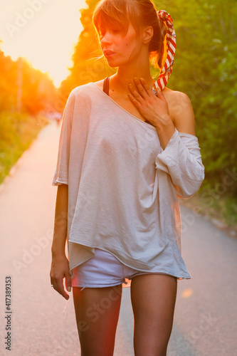 Portrait of a young woman in the summer at sunset