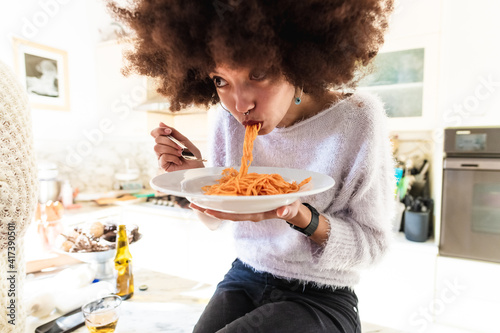 Young woman eating spaghetti
