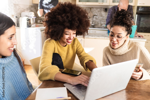 Friends looking at laptop together