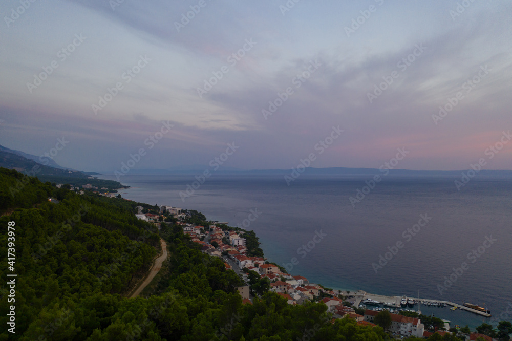 Famous Adriatic coast. Aerial evening view of picturesque coastline in Makarska riviera, Brela, Croatia, Europe. Splendid Adriatic sea, mountains and a village by the sea. Breathtaking landscapes.