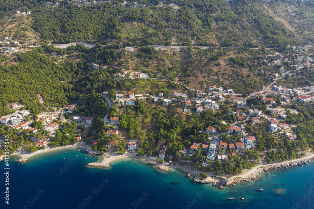 Famous Adriatic coast. Panoramic aerial view of picturesque coastline in Makarska riviera, Brela, Croatia, Europe. Splendid Adriatic sea, mountains and a village by the sea. Breathtaking landscapes.