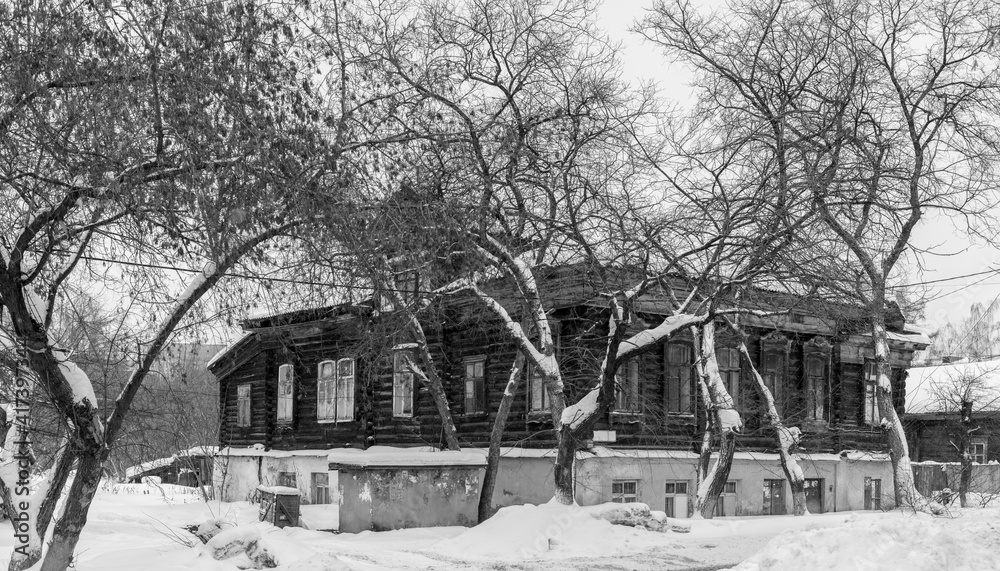 Old wooden houses under the snow. Russia. Siberia. Winter. The city of Tomsk 2021