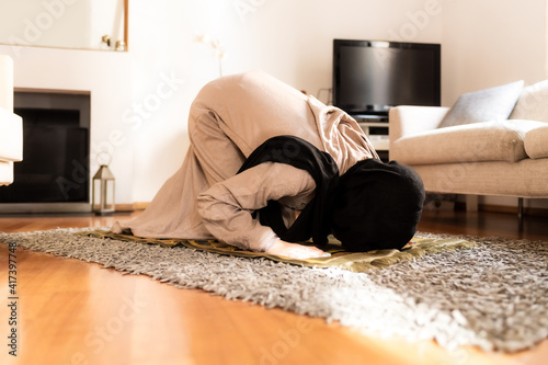 Muslim woman praying, in sujud position