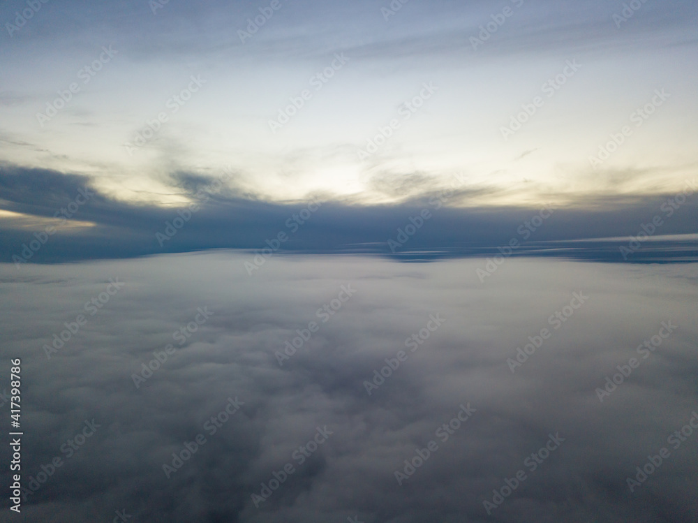 High flight above the clouds at sunset. Aerial view. High flight above the clouds at sunset. Aerial view.