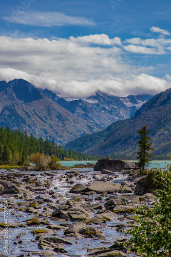 View of the snowy peaks from the noises of the second multinsky lake in the mountains of Altai