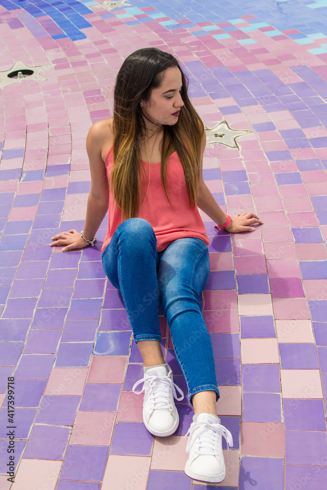 Young Woman Sitting And Smiling On A Terrace Young Woman Sitting And Smiling On A Terrace